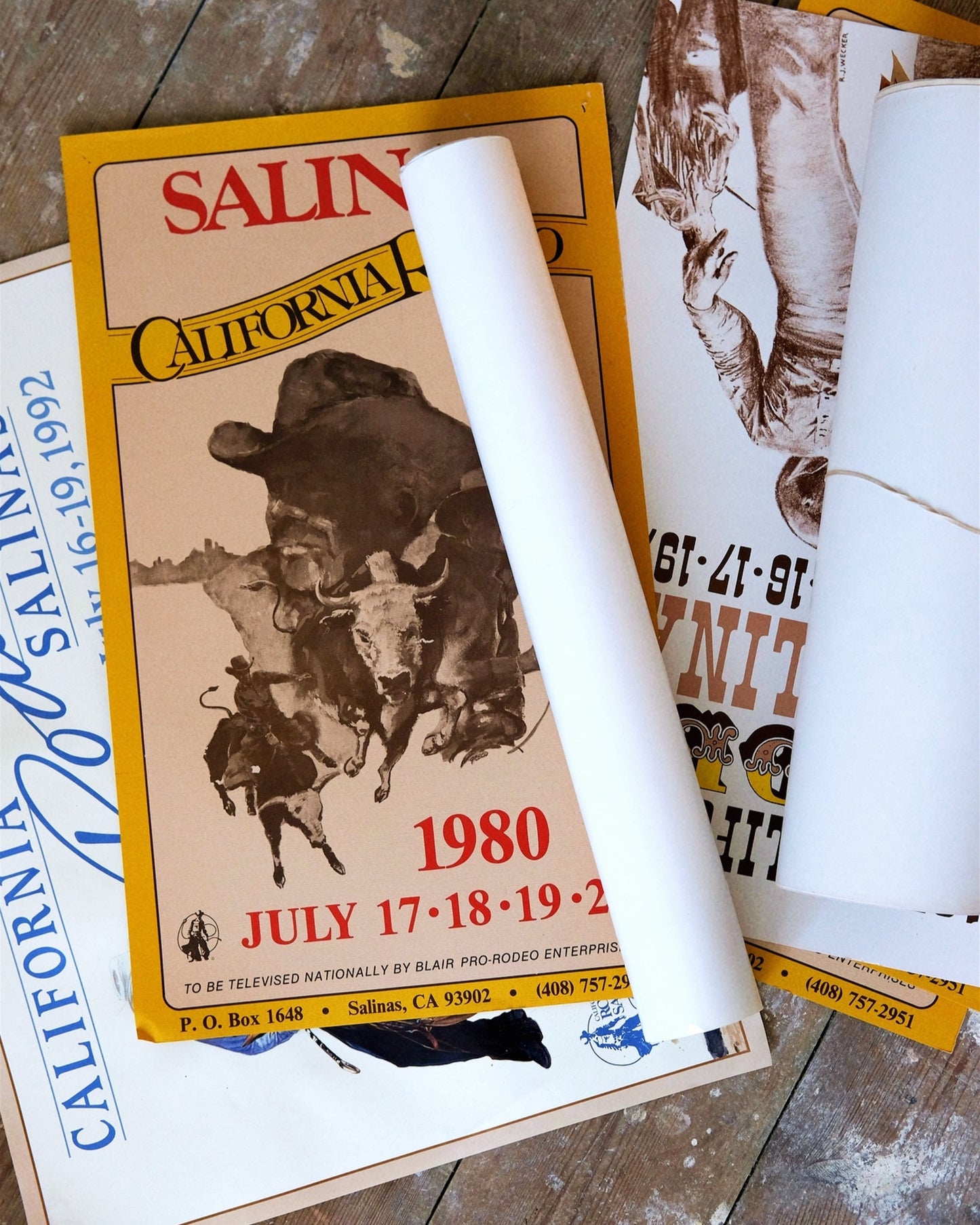Vintage Salina California rodeo poster from 1980 with a white cylindrical object on top.